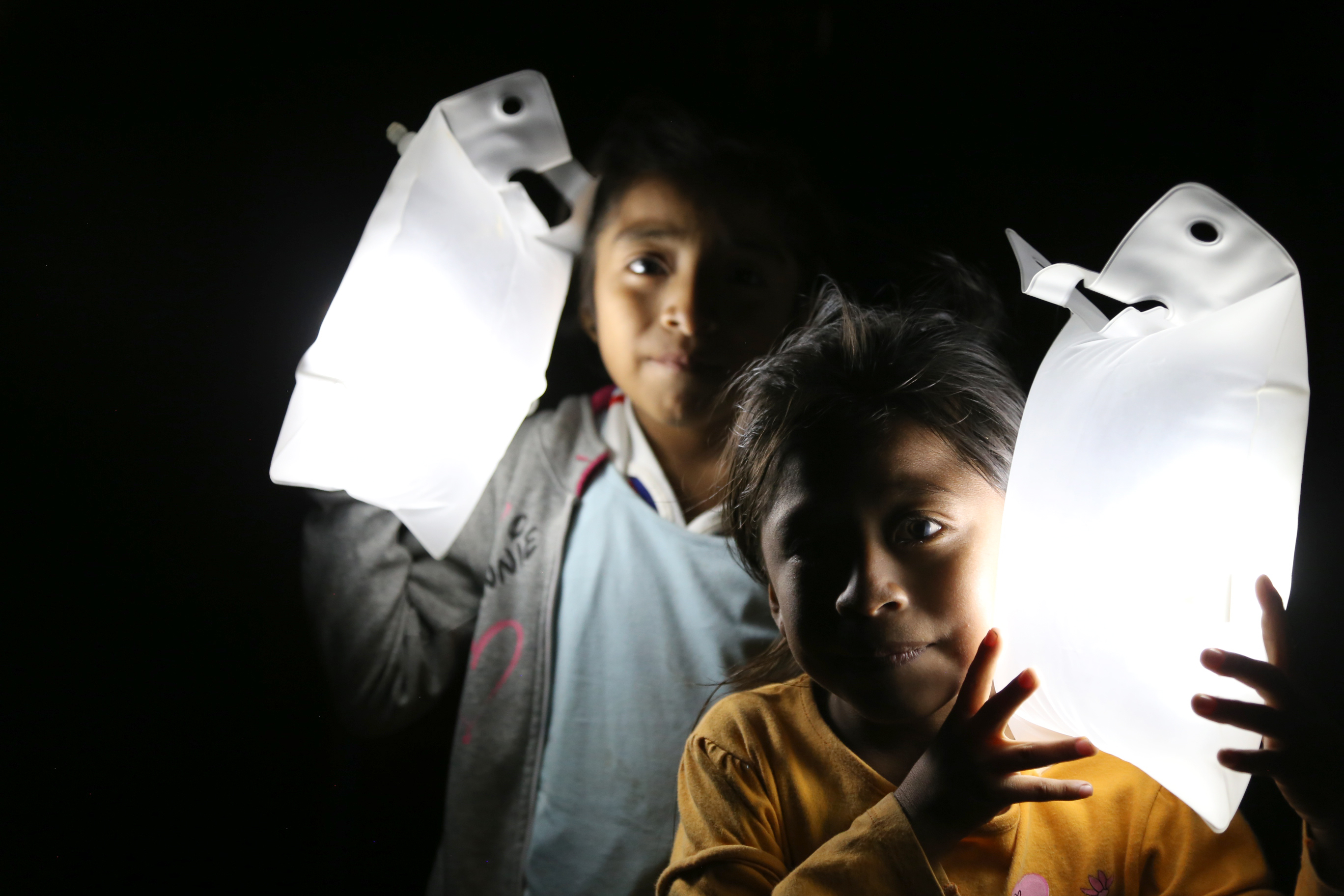 Children showing the Large size solar lights in the dark