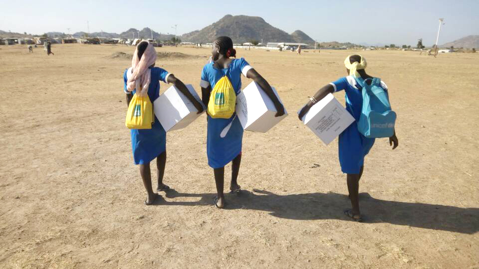 Carrying aid items across the dry landscape