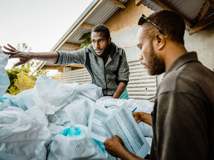 Men loading aid on a truck in Vanuatu