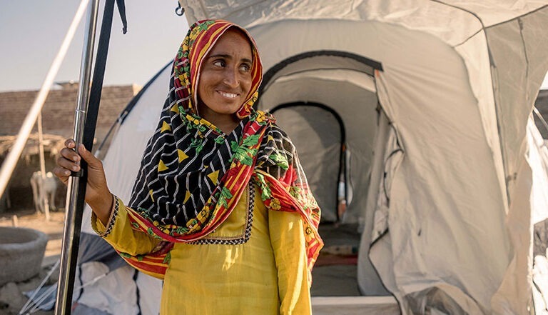 Pakistan woman in front of ShelterBox tent
