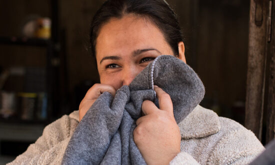 Woman holding a blanket to her face