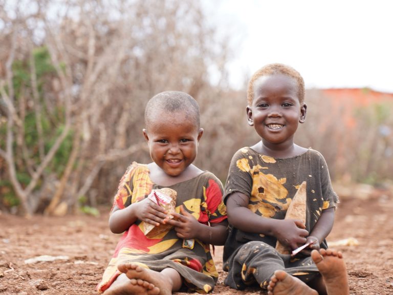 Two small boys sitting on the ground in Somalia