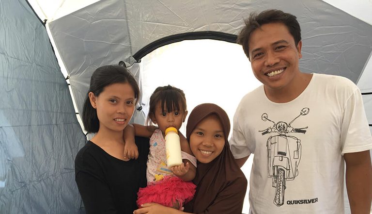 Family in Indonesia in a tent