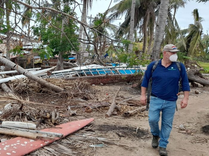 Man walking next to destroyed buildings in the Philippines